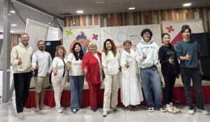 Kindersitzen in einem Kunstmuseum auf dem Boden und hören den Kuratoren zu.